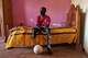 Omer al-Toum, 33, who lost his leg and arm by the explosion of unexploded ordnance, sits in his bedroom in Bahri, on the outskirts of Khartoum, Thursday, April 23, 2026.