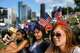 Claudia Knoll, Megan Gusman and Hailee Higgins, enjoy a performance at the Freedom Over Texas festival, Monday, July 4, 2016, in Houston.