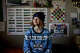 Ren Fitzgerald, 18, wears a BART holiday sweater inside their dorm room on the UC Berkeley campus on Nov. 20, 2023. BART is appealing to transit superfans with kitschy swag in an effort to win back commuters.