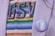 A Valkyries staff member dons a Pride button and Pride T-shirt (designed by Peau De Loup) on Friday prior to the Valkyries game against the Atlanta Dream during Pride Night at Chase Center.