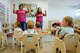 Large portions of Dallas County remain childcare deserts where demand far exceeds supply, write Tori Mannes, Karen Hughes White and Susan Hoff. In this file photo, caregivers lead a song at Little Mustangs Child Learning Academy, in Richardson, Texas.