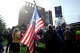 A man carries a United States flag at a No Kings rally in front of Stamford Superior Court on October 18, 2025.