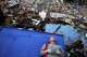 Resident Kerli Faria takes a interruption amid the rubble portion searching for her nephews astatine a gathering that collapsed during the earthquakes that struck La Guaira, Venezuela, Tuesday, June 30, 2026.