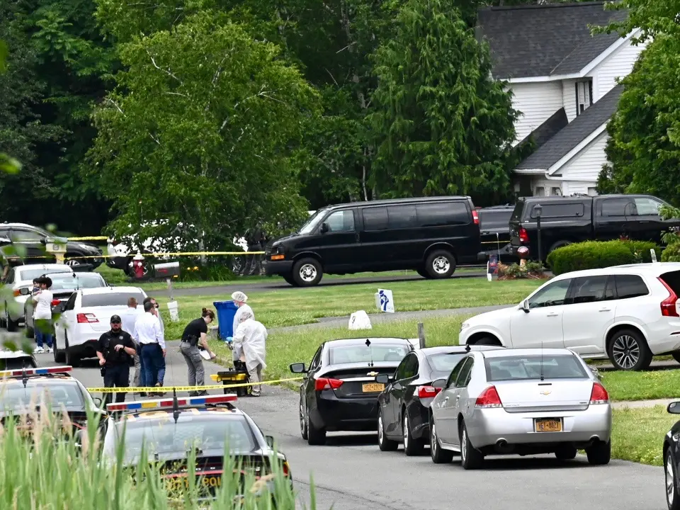 Police gather Tuesday morning on Park Drive in Menands, where 7-year-old Harbe Nagi's bod