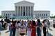 A group prays outside of the Supreme Court ahead of the court's ruling on whether transgender girls and women can play on school athletic teams, Tuesday, June 30, 2026, on Capitol Hill in Washington.