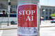 Red STOP AI protest flyer with meeting details taped to a light pole in San Francisco on May 20, 2025.
