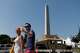 People cross 15th Street Northwest as a National Guard Humvee blocks the roadway, Wednesday, July 1, 2026, in Washington.