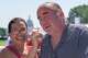 Stephanie McCallister holds a cold bottle of water to her husband Don McCallister's neck as they wait in line for the ferris wheel at the Great American State Fair on the National Mall, Wednesday, July 1, 2026, in Washington.