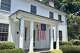 An American flag commemorating 1776 hangs in July 2026 from the Ezekiel Lockwood House on Round Hill Road in Greenwich, Connecticut, which had been standing more than 30 years at the time of the Declaration of Independence. On the heels of the $4.1 million sale in January of a 1758 colonial at 331 Round Hill Road, another from the colonial era is listed for sale in the Charles Green House at 660 Round Hill Road for $6.9 million, one of less than 60 on the Connecticut market that are older than the nation.
