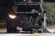 A battered bumper hangs off a Houston Police Department cruiser in a northwest Houston gas station after an officer was involved in a crash overnight.