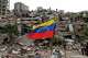 Residents and rescue workers search through the rubble of buildings damaged in the earthquakes that struck La Guaira, Venezuela, Thursday, July 2, 2026.