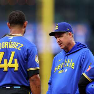 Mariners' Rodriguez removed after being hit in helmet by thrown ball