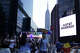 The Empire State Building is seen in the distance as people take photos of a giant screen showing the message "JUST&T MARRIED!" (T&T for Taylor and Travis) outside Madison Square Garden, the reported venue for the wedding celebrations of Taylor Swift and Travis Kelce, in New York on Friday, July 3, 2026.
