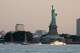 A U.S. Coast Guard vessel sits with other pleasure craft below the Statue of Liberty in the New York harbor ahead of Sail250, a gathering of tall ships and military ships honoring America's 250th Anniversary, Saturday, July 4, 2026, in New York.