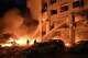 Emergency services personnel work to extinguish a fire following Russian missile attacks in Kyiv, Ukraine, Monday, July 6, 2026.