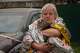 A woman carries her cat out of a damaged multistory apartment building following a Russian missile attack in Kyiv, Ukraine, Monday, July 6, 2026.