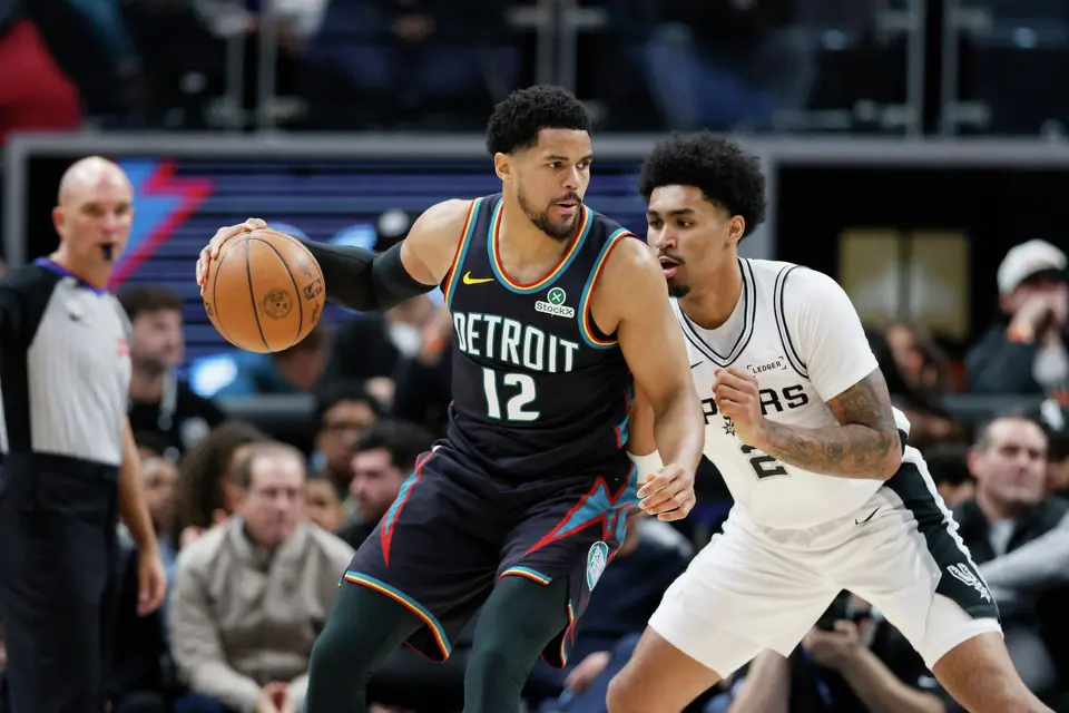 Detroit Pistons forward Tobias Harris (12) drives against San Antonio Spurs guard Dylan Harper (2) during the first half of an NBA basketball game Monday, Feb. 23, 2026, in Detroit. (AP Photo/Duane Burleson)