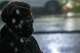A member of the Brown Berets addresses protesters in the rain during a protest following an officer-involved shooting during a federal immigration enforcement operation in Houston on Tuesday, July 7, 2026. The shooting is under investigation by the Federal Bureau of Investigation.