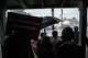 Protesters continue chanting beneath the porch of a local business as heavy rain falls during a protest following an officer-involved shooting during a federal immigration enforcement operation in Houston on Tuesday, July 7, 2026. The shooting is under investigation by the Federal Bureau of Investigation.