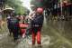 In this photo released by Xinhua News Agency, rescuers evacuate stranded residents in the aftermath of tropical storm Maysak in Qinzhou City, south China's Guangxi Zhuang Autonomous Region Tuesday, July 7, 2026. (Zhang Ailin/Xinhua via AP)