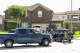 Immigration and Customs Enforcement officers stand outside of a residence on Saint Winfred street after a man who they were pursuing barricaded himself inside the house in Spring, Wednesday, July 8, 2026.
