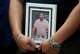 Ronaldo Salgado, son of Lorenzo Salgado Araujo, holds a photo of his father during a news conference about the ICE shooting death in Houston Wednesday, July 8, 2026.