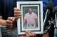 Ronaldo Salgado and Lorenzo Jr., sons of Lorenzo Salgado Araujo, hold a photograph of their father during a news conference Wednesday, July 8, 2026, in Houston.