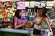Rep. Haley Stevens, D-Mich., speaks with twin sisters Anna and Grace Thompson, 17, at the Decadent Dogs pet store in South Haven, Mich., on Tuesday, July 7, 2026.