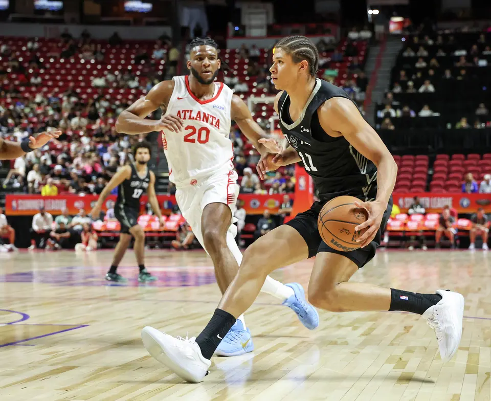 Carter Bryant #11 of the San Antonio Spurs drives against Zuby Ejiofor #20 of the Atlanta Hawks in the first half of a 2026 NBA Summer League game at the Thomas & Mack Center on July 09, 2026 in Las Vegas, Nevada.