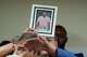 A photograph of Lorenzo Salgado Araujo is passed to the front during a news conference Wednesday, July 8, 2026, in Houston.