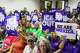 Community members hold signs reading "ICE Out" during a community vigil for Lorenzo Salgado Araujo in Houston on Saturday, July 11, 2026. (Raquel Natalicchio/Houston Chronicle via AP)