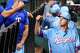 Texas Rangers pitcher MacKenzie Gore fits bumps teammates in the dugout prior to a baseball game against the Houston Astros at Globe Life Field on Sunday, July 12, 2026, in Arlington.