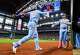 Texas Rangers shortstop Ezequiel Duran (20) celebrates with Texas Rangers designated hitter Joc Pederson (right) after scoring a run during the second inning of a baseball game at Globe Life Field on Sunday, July 12, 2026, in Arlington.