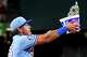 Texas Rangers second baseman Nicky Lopez tosses bubble gum in the air after Rangers right fielder Brandon Nimmo hit a walk-off single during the ninth inning of a baseball game against the Houston Astros at Globe Life Field on Sunday, July 12, 2026, in Arlington.