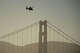 A helicopter goes past the Golden Gate Bridge as part of search and rescue efforts near the site of boat accident on Tuesday in San Francisco.