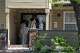 John Boisa and others walk into his house on Wednesday, July 15, 2026 in Stockton, Calif. Boisa is confirmed to be the captain of the boat, Volare, that capsized on Tuesday near Alcatraz. 20 people were aboard, with 16 rescued, three missing, and one pronounced dead.