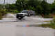 A Texas Department of Public Safety vehicle drives through standing water in Uvalde on Wednesday.