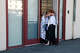 Two people embrace in the doorway of a reunification center at Fort Mason on Tuesday in San Francisco. One person died and three remained missing.
