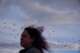 Birds fly above as Jean Booth, who was targeted in a romance scam, walks on the beach in Huron, Ohio, Dec. 8, 2025.