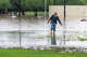 Julian Garza, owner of Koyote RV Trailer Park, gathers items stuck in floodwater along North Camp Street in Uvalde on Thursday morning, July 16, 2026.