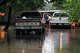 Bill Dozier hops out of his truck into floodwater as he checks on his house along North Camp Street in Uvalde on Thursday, July 16, 2026. He said water was up to his ankles inside his home.