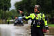 A first responder with the Texas Game Wardens gives directions while preparing for a water rescue on East Mesquite Street in Uvalde on Thursday, July 16, 2026, where the Leona River flooded.
