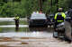 First responders with the Texas Game Wardens ask residents if they are safe as they make their way down East Mesquite Street in Uvalde on Thursday, July 16, 2026, after the Leona River flooded the roadway.