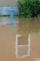 A mobile home is reflected in floodwater at Koyote RV Trailer Park after more floodwaters arrived in Uvalde on Thursday morning, July 16, 2026.