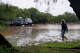 Julian Garza, owner of Koyote RV Trailer Park, gathers items stuck in floodwater along North Camp Street in Uvalde on Thursday morning, July 16, 2026.