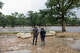 Gary Shipman and Sofia Patton look across the Guadalupe River over at their ranch from Howdy’s Bar and Grill on Thursday, July 16, 2026, in Kerr County.