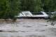 The Perdenales River floods over Mark Isbell’s RV home at Arrowhead Creek Vineyards in Stonewall, Thursday, July 16, 2026. Isbell, his wife Kim and their dog were able to evacuate the RV before the flood swelled and overtook their home.