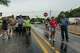 People gather to watch as the Perdenales River floods Ranch Road 1623 in Stonewall, Thursday, July 16, 2026.