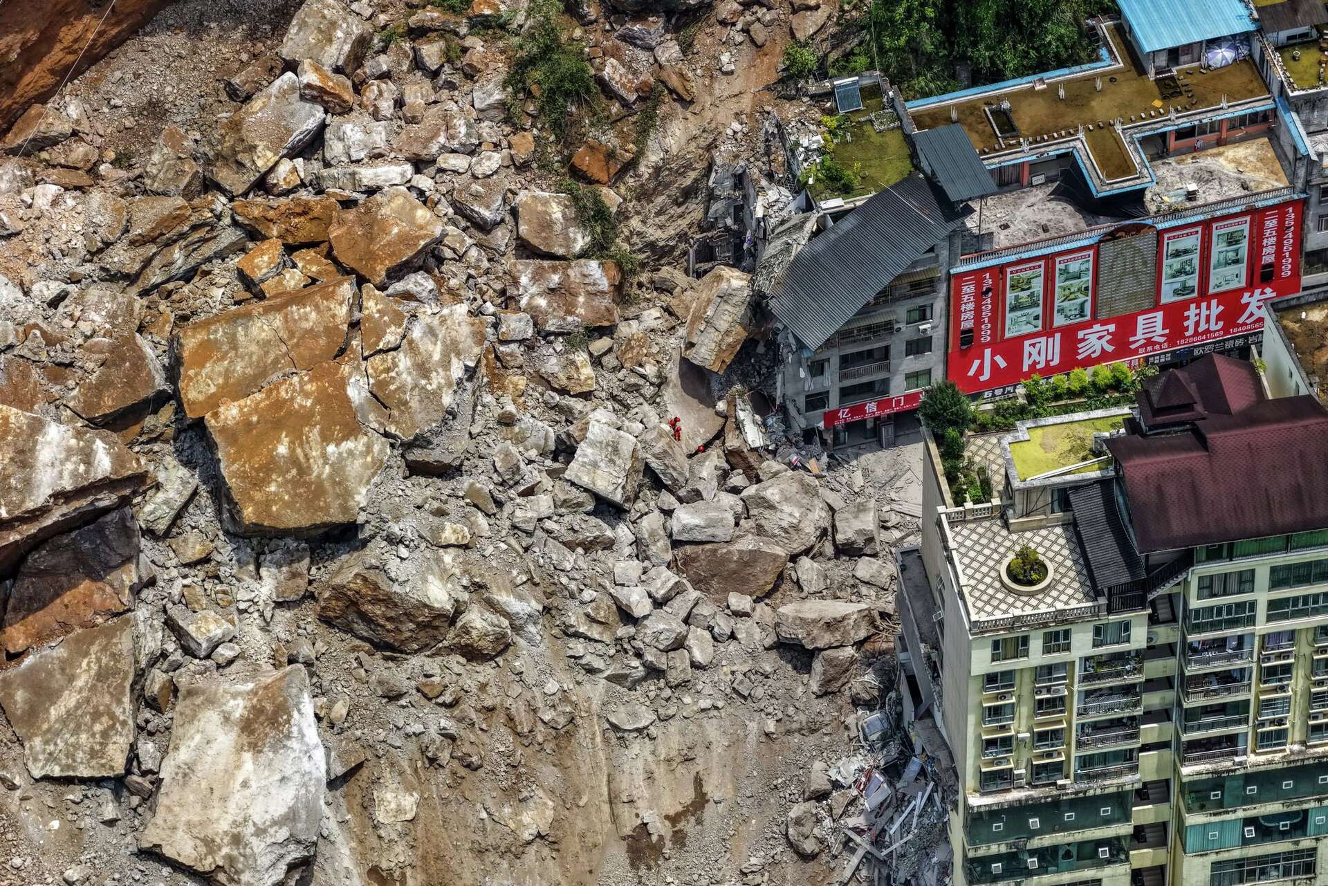 A huge landslide in southwest China buries homes and force more than 1,000 to evacuate