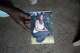 The son of Mary Olouch, who died at 25 after a botched abortion procedure, holds a photo of her in her home in Karabok, Kenya, July 20, 2025.